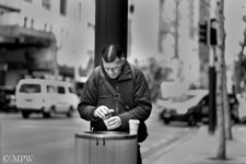 checking the bins in Queen St for his morning coffee